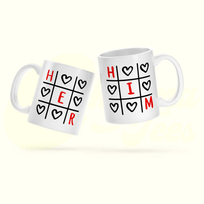 Two white mugs with 'HER' and 'HIM' designs on a white background